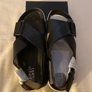New women’s Franco Sarto cross cross leather sandals in black with white bottom.